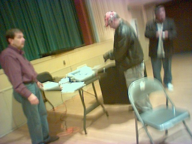 HDO - Touching Tally Machine as election judge looks on.